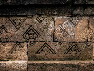 patterns carved into the walls of restored old temples in Indonesia
