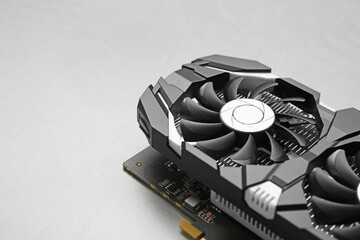 Computer graphics card on gray textured background, closeup. Space for text