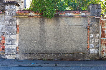 Cracked Urban Wall with Brickwork and Rusty Metal Gate