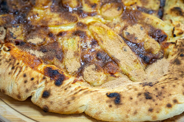 Traditional sweet Brazilian banana pizza with cinnamon, chocolate and catupiry