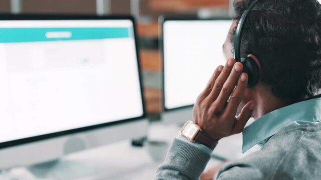 Businessman, consultant and call center with headphones on computer for customer service or support at office. Man, agent or employee consulting with screen for online advice, help or assistance