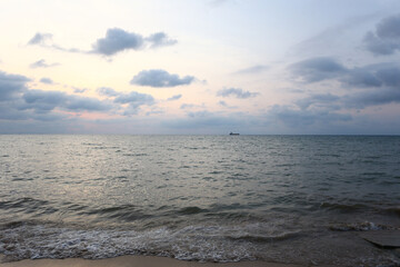 Along the shore of the Black Sea, in the evening the sun was about to set and there were black clouds tinged with orange.