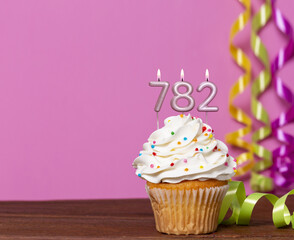 Birthday Cupcake With Candles Lit Forming The Number 782