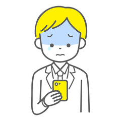 スマホを見て泣いている男子学生