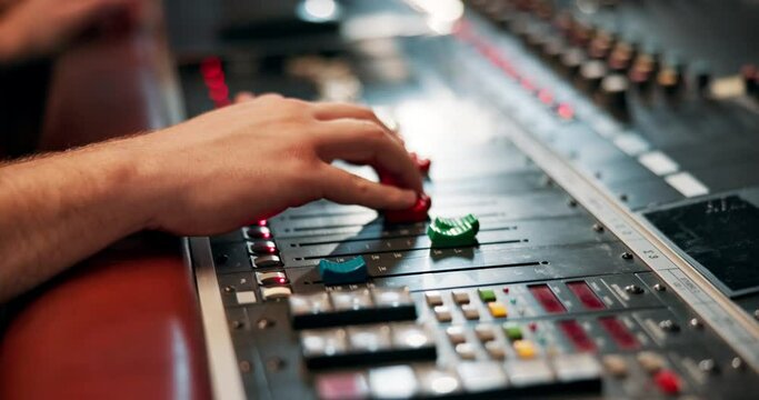 Studio, hand and engineer with music equipment for volume level, frequency mode and control. Person, sound producer and audio mixer for track record, consistency and creativity with workstation