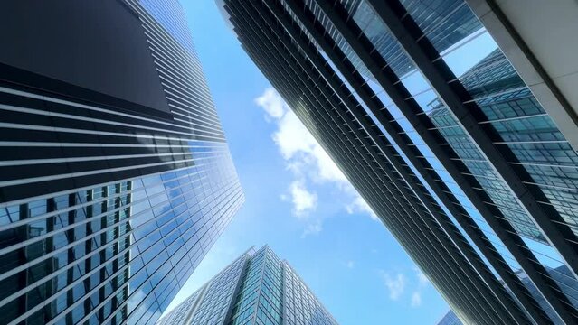 Skyscrapers rise against a bright blue sky in a cityscape view