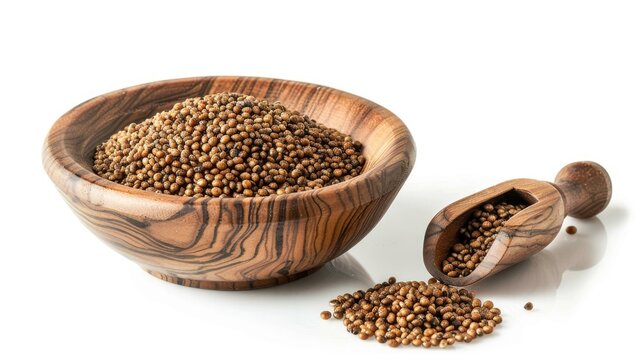 Sorghum seeds in a wooden bowl and scoop on a white background with complete depth of field