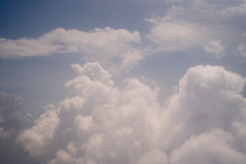 Cumulus clouds in the blue sky.
