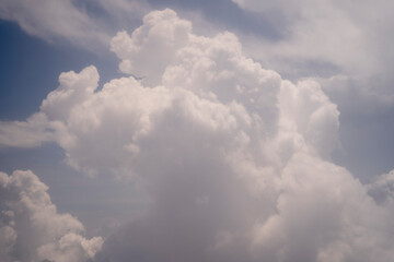 Cumulus clouds in the blue sky.