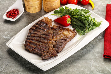 Grilled chuck roll steak with arugula