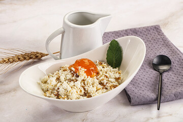 Curd with granola and orange jam