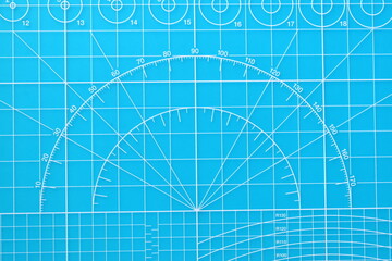 blue cutting mat board background with line and scale measure guide pattern for object art design, tool equipment of diy craft work