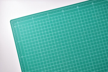 green cutting mat board on white background with line and scale measure guide pattern for object art design, tool equipment of diy craft work