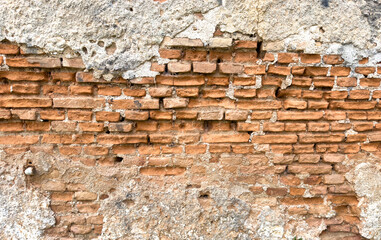 Empty aged brown stonewall background texture. Old, worn wall, peeled plaster. Blank, copy space