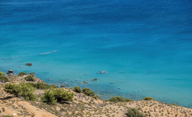Ripple sea water, above view of sandy bottom with few pebble background, copy space. Greek nature