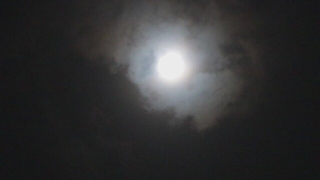 moon and clouds in dark night, full moon and moving clouds
