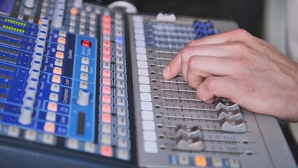 A man operates a mixing console.
