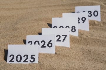 Paper cards with numbers of years from 2024 to 2030 in a row. New year start concept. Resolution...