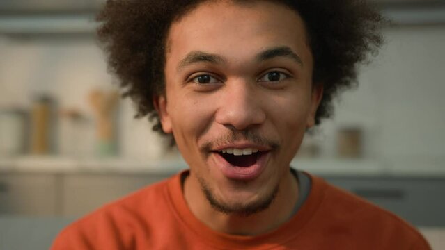 Close up happy excited African American man wonder male face surprised guy shocked amazed person at home indoors looking at camera say wow achieve good news reaction amazing wonderful unexpected win