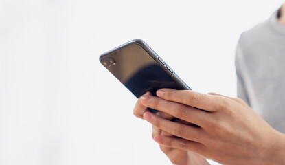 Woman holding a smartphone and using social media on internet.