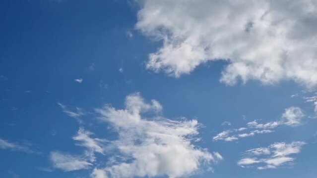 Cumulus fluffy clouds dissolving in blue clear sky hyperlapse