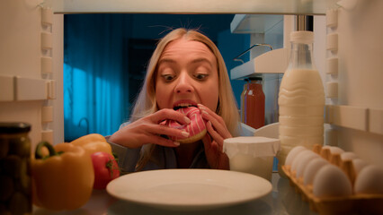 Point of view POV from inside refrigerator hungry Caucasian woman girl at night evening kitchen...