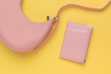 Pink Passport Holder Next to Stylish Pink Bag on Yellow Background