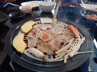 Grilling meat and vegetables on a hot stove