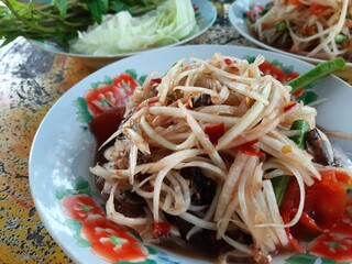 Spicy Papaya Salad with Pickled Crabs on a Plate