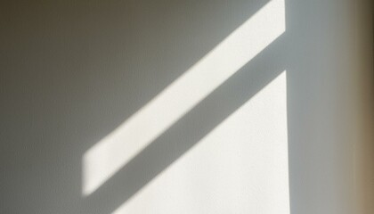Blurry light shadow from window on white wall background