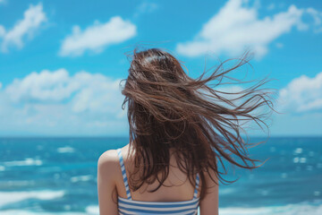 Obraz premium a woman with long hair standing on a beach