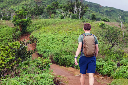 Man with a backpack hiking, view from the back, Hawaii, Maui