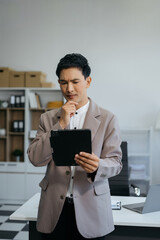 stressed Asian businessman working in the office. Businessman thinking too much work concept in the...