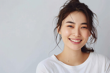 a woman with a white shirt smiling and looking at the camera