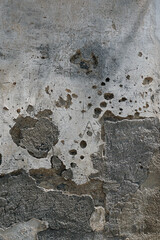 Wall in an Italian town with old plaster worn by time