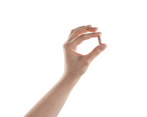 Female hand hold beige pill isolated on white