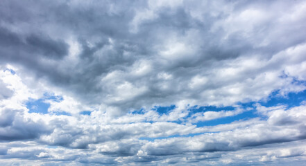 Beautiful blue sky with fluffy white clouds creating a serene background scene