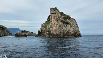 Rocks and mountains on the Amalfi coast in Italy. The island is a rock. View from the yacht.