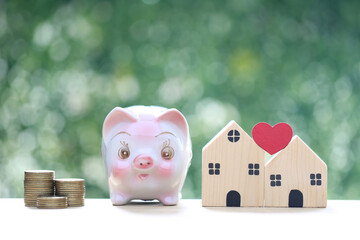 Finance, Model house with piggy bank and stack of coins money on natural green background,Business...