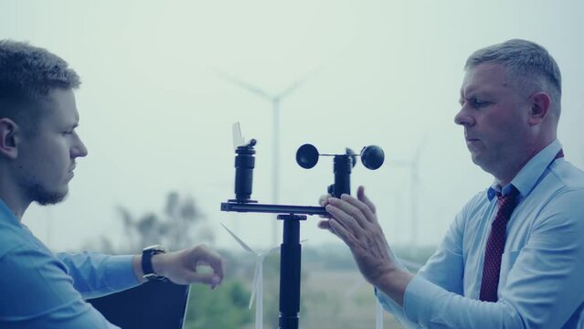 people working together.  Team engineer, business with wind turbine model on wind farm, Project presentation work.