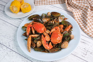 Seafood with sour sweet sauce on white plate