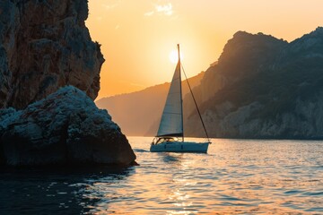 A sailboat calmly navigates waters near rocky cliffs under the warm glow of the sunset