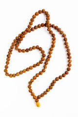 Handmade rudraksha seed necklace, isolated on white background. Used in Hinduism and Buddhism.