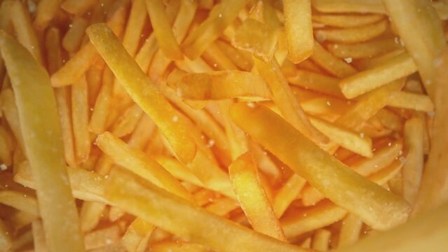 Super Slow Motion Shot of Falling French Fries and Salt Followed by Camera at 1000 fps.