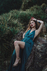 Indigenous woman posing in a garden of cactus and flowers 