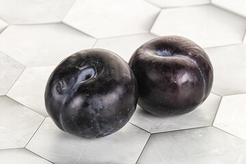 Two ripe sweet black plums