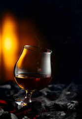 Snifter of brandy on a burning charcoal.