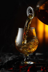 Cognac or brandy being poured into a glass.