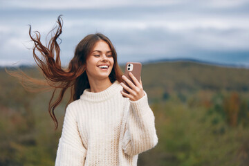 Mountain Woman Enjoying Freedom in Nature with Phone Connection