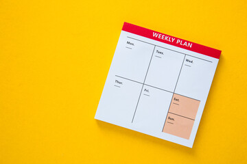 Colorful weekly planner with yellow background